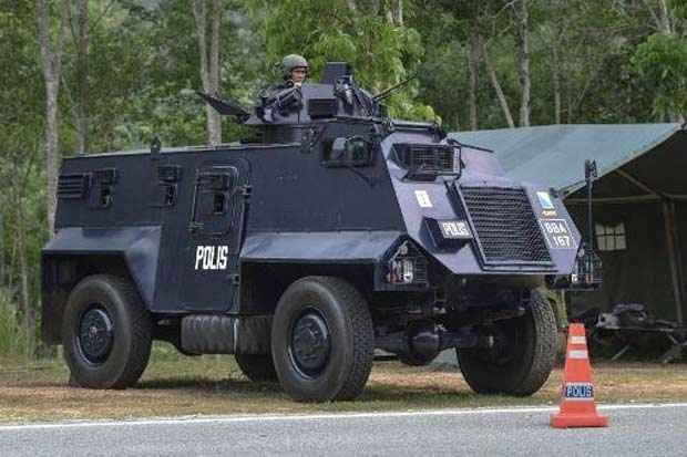 Tanque da polícia da Malásia em posto de controle em Wang Kelian, perto da fronteira com a Tailândia. Foto: Mohd Rasfan/AFP/ Tanque da polícia da Malásia em posto de controle em Wang Kelian, perto da fronteira com a Tailândia. Foto: Mohd Rasfan/AFP/