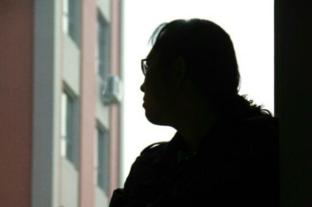 Uma transexual, que preferiu permanecer no anonimato, é vista em seu apartamento, em Jinzhou, China. Foto: HANDOUT/AFP/Arquivos Handout/