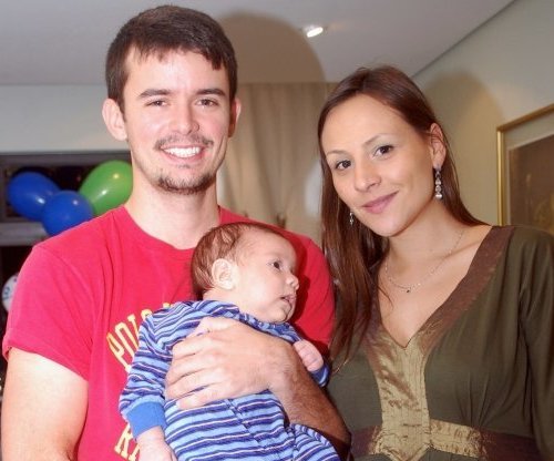 Analy Rosa e Alan Pierre segurando seu filho Theo alguns anos atrás