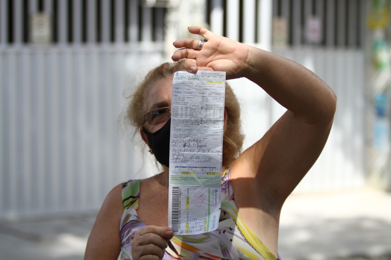 A moradora Marilene de Melo mostra a conta de água