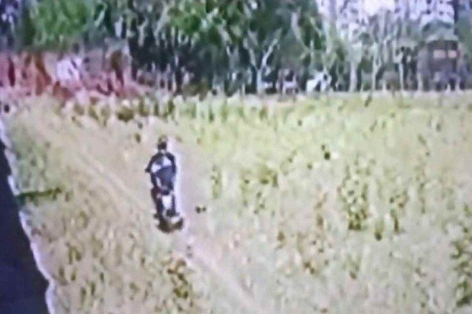 Câmeras de segurança flagraram, no interior paulista, um motociclista ateando fogo em vegetação seca/foto: Reprodução Câmeras de segurança flagraram, no interior paulista, um motociclista ateando fogo em vegetação seca/foto: Reprodução