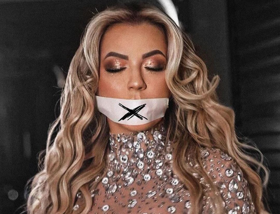 Apenas com a legenda ''carta aberta'', o post traz a imagem de Deolane com a boca tapada por um pano branco com um X desenhado/Foto: Reprodução/Redes sociais Apenas com a legenda ''carta aberta'', o post traz a imagem de Deolane com a boca tapada por um pano branco com um X desenhado/Foto: Reprodução/Redes sociais