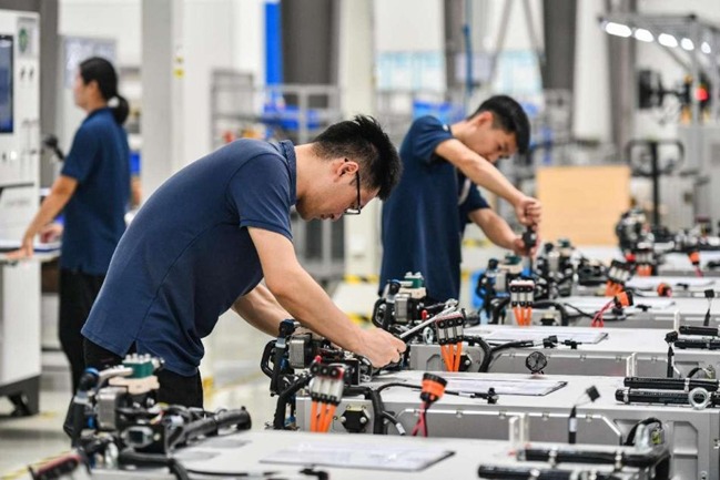 écnicos verificam motores de célula de combustível de hidrogênio em uma oficina da Jinhua HydroT Tech Co., Ltd. 
