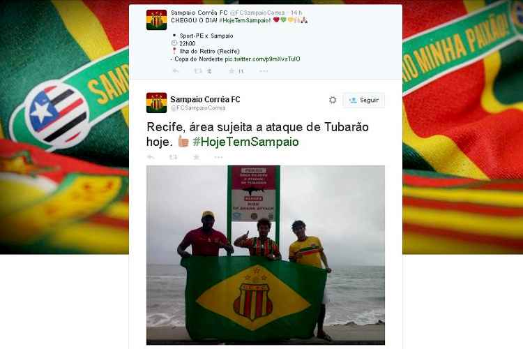 Torcedores tiraram foto em frente a uma  placa de alerta contra ataques de tubarão 